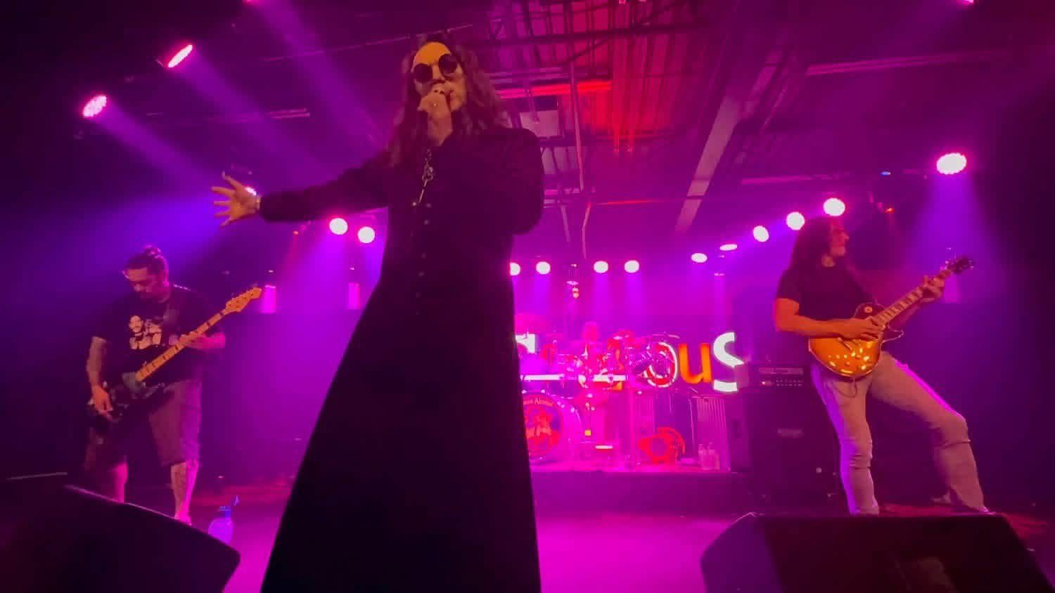 Demon Alcohol on stage under purple lights